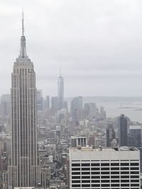 City skyline against cloudy sky