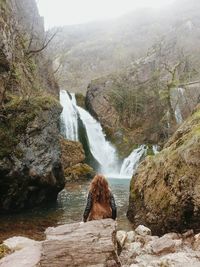 Scenic view of waterfall against sky