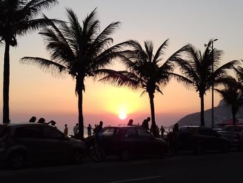 Silhouette palm trees against sky during sunset