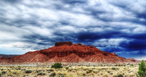 Low angle view of castle on mountain against cloudy sky