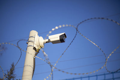 Camcorder on the fence. protected area. perimeter security. barbed wire and surveillance. 