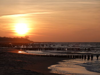 Scenic view of sea against orange sky