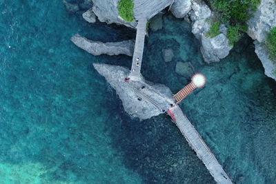 High angle view of umbrella on rock by sea