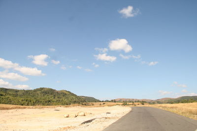 Empty road along countryside landscape