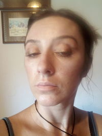 Close-up portrait of woman at home