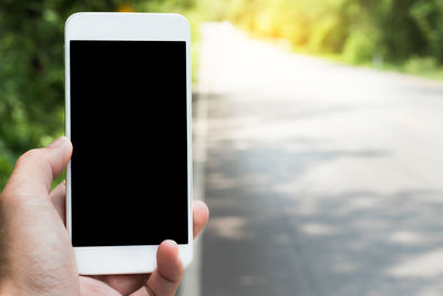 Close-up of hand holding mobile phone