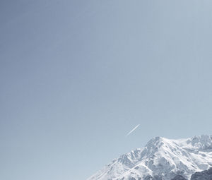 Scenic view of snowcapped mountains against clear sky