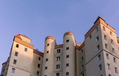 Low angle view of buildings against blue sky