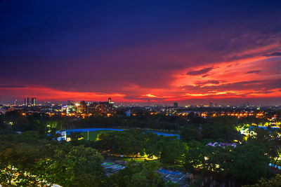 High angle view of illuminated buildings against sky at sunset