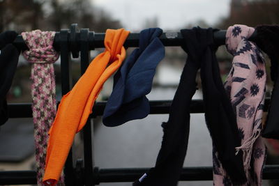 Close-up of clothes hanging on metal railing