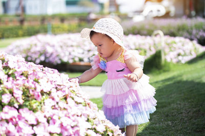 Full length of woman with pink flowers