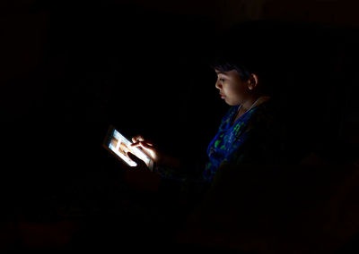 Man using mobile phone at night