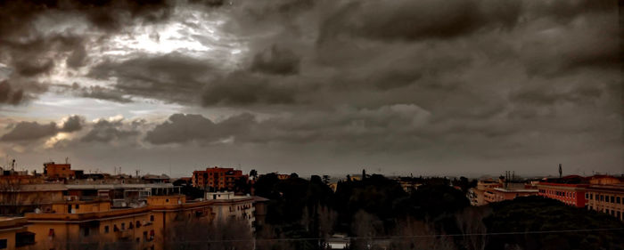 Buildings against cloudy sky