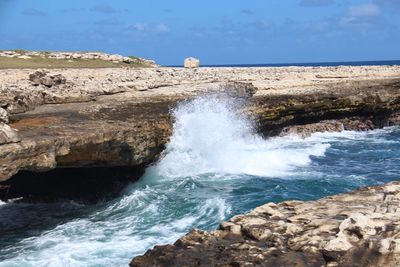 Scenic view of sea against rocks