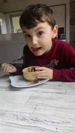 Portrait of boy eating food