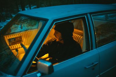 Portrait of man sitting in car