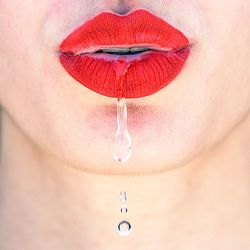 Water flowing through red lips