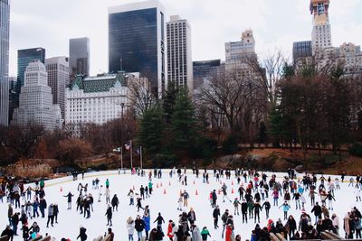 Crowd in city ice skating  during winter