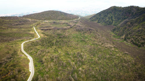 Scenic view of road amidst mountains against sky