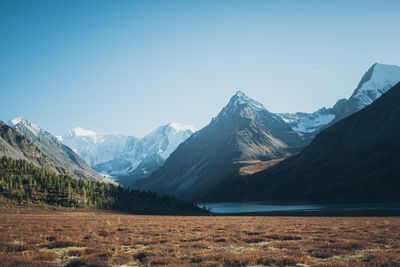 Scenic view of snowcapped mountains against clear sky