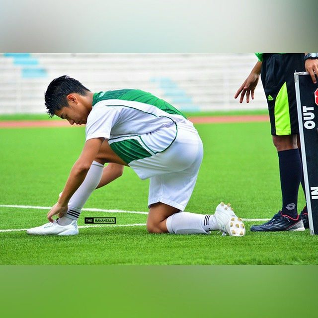 lifestyles, leisure activity, grass, full length, casual clothing, childhood, person, enjoyment, side view, playing, young adult, sport, green color, field, standing, fun, playful