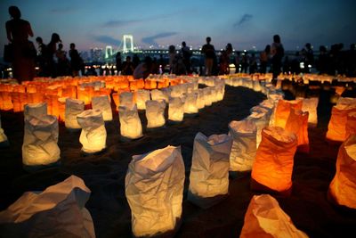 People by illuminated lanterns at dusk