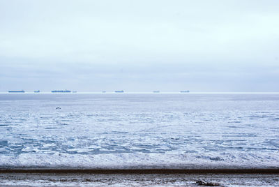Scenic view of sea against sky during winter