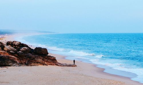 High angle view of man standing at sandy beach