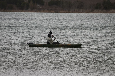 Man sitting on boat in sea