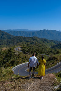 Rear view of man walking on mountain