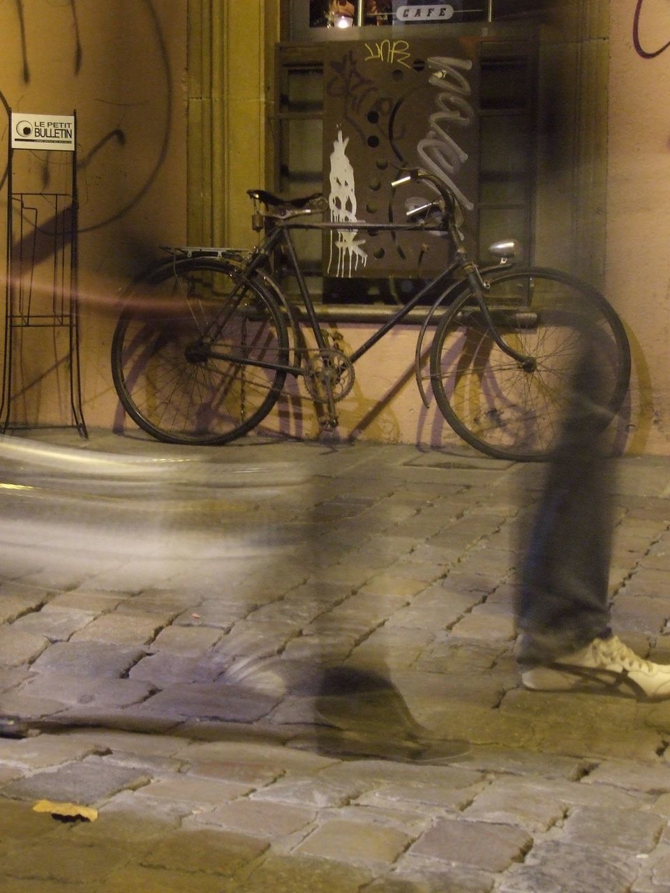 BICYCLE LEANING AGAINST WALL