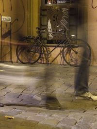 Bicycle leaning against wall in city