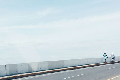 Woman walking on road