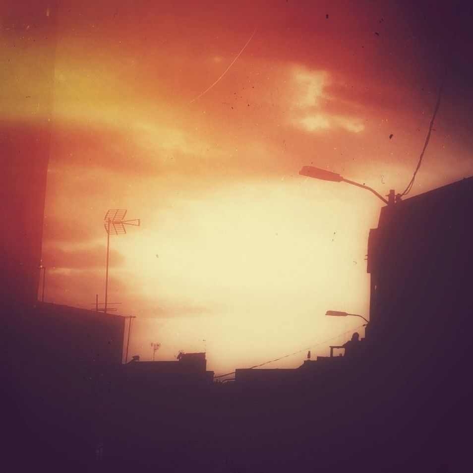 sunset, silhouette, built structure, architecture, sky, transportation, building exterior, power line, indoors, dusk, orange color, electricity, electricity pylon, dark, street light, street, fuel and power generation, illuminated, no people