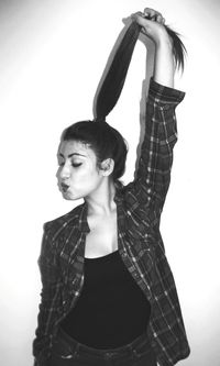 Portrait of young woman against white background