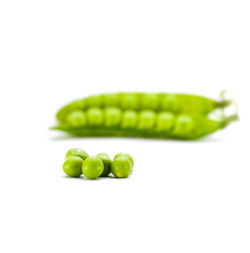 Close-up of green chili pepper over white background