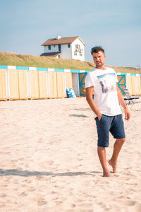 Full length of man standing on sand at beach