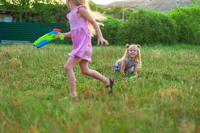 Happy girls playing on field