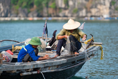 People sitting on boat in sea