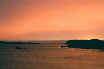 Scenic view of sea against orange sky