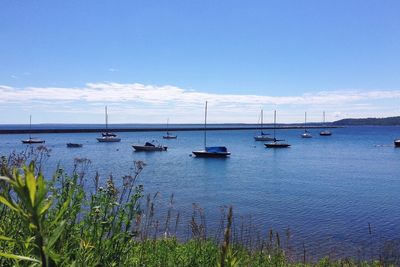 Boats in sea against sky