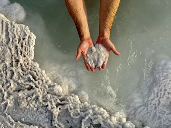 Low section of person swimming in sea