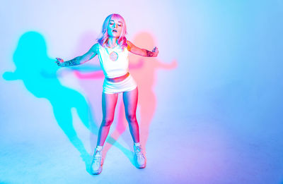 Full length of woman standing against white background