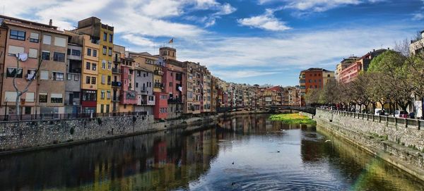 Bridge over river with buildings in background