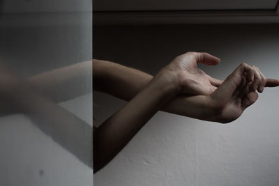 Close-up of hand on wall at home