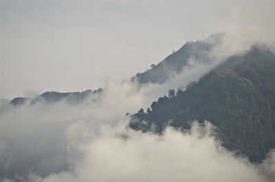 Scenic view of mountains against cloudy sky