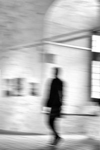 Blurred motion of person walking on railroad track