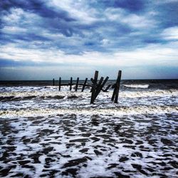 Scenic view of sea against cloudy sky