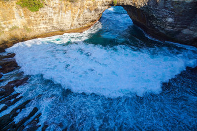 High angle view of wave coming through cave