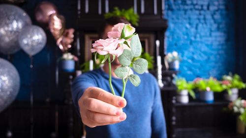 Close-up of hand holding flowers